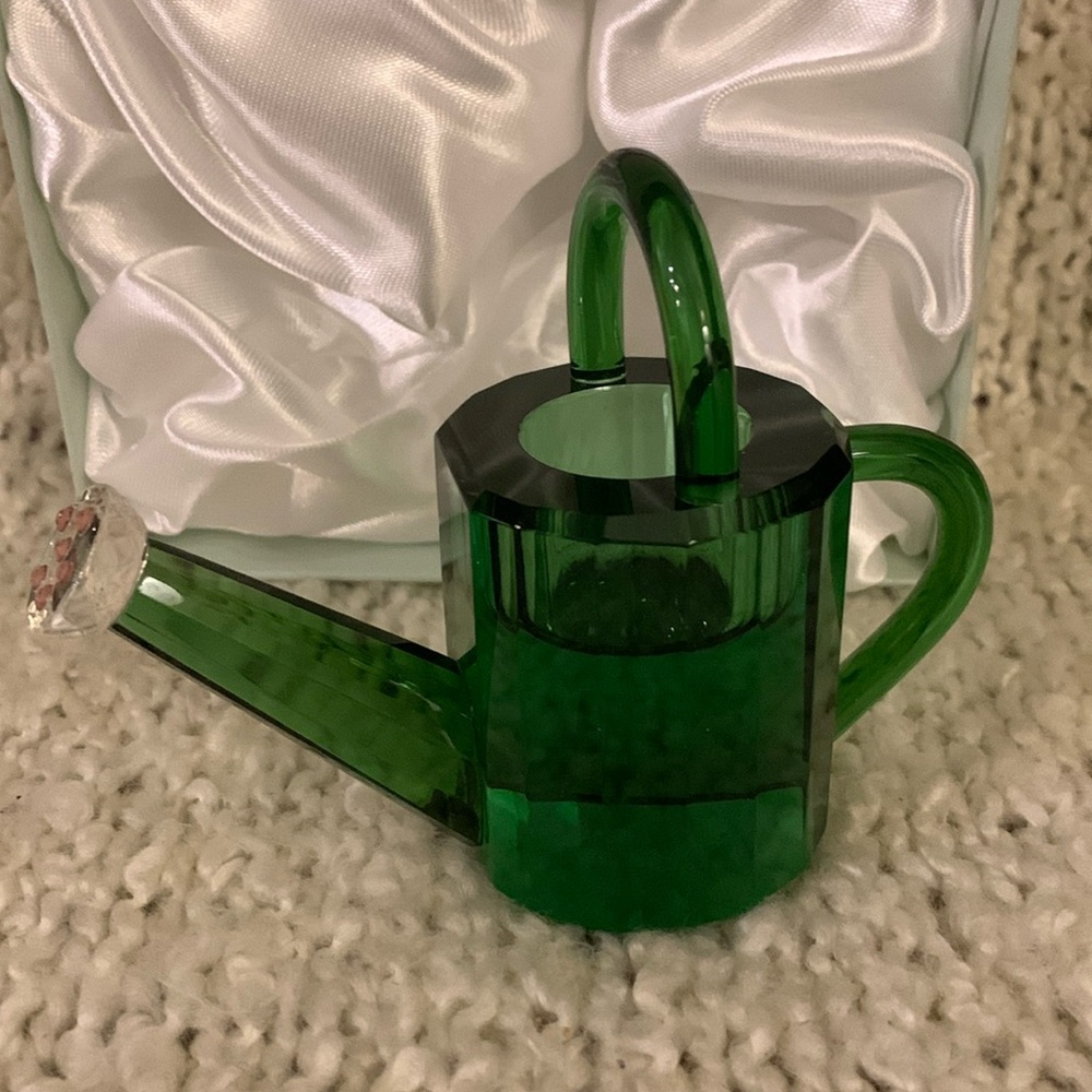 Crystal paperweight, green watering can.